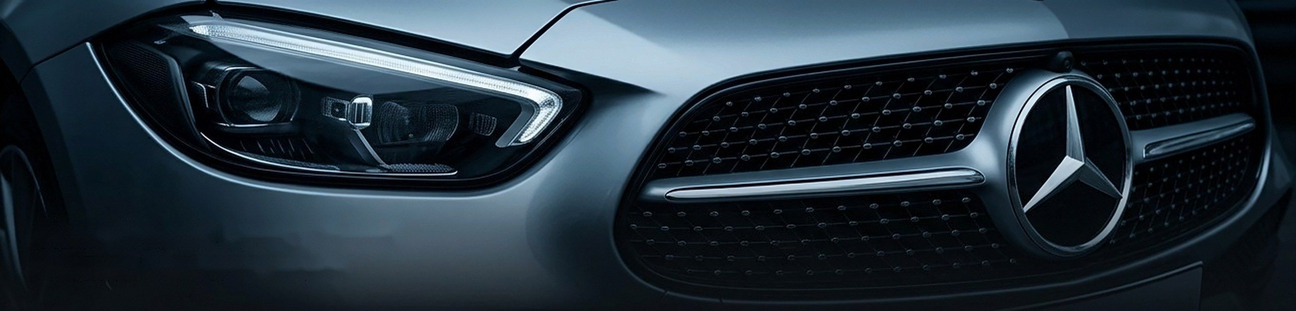 Close-up of a modern German luxury car's headlight and grille
